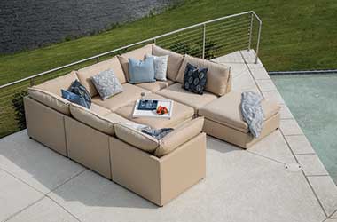 tan c-shaped couch on a deck
