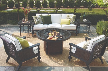 outdoor sofa, side tables and chairs with round fire pit table in the center