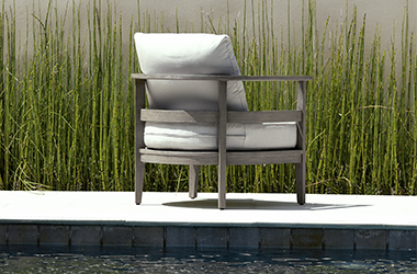 poolside chair in front of tall grass
