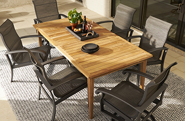 light wooden dining table and dark gray chairs