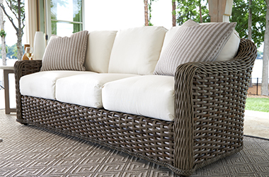 dark brown woven couch with white cusions