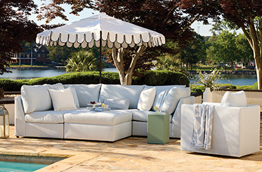 tan c-shaped couch on a deck