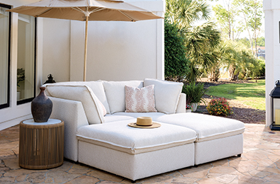 tan c-shaped couch on a deck
