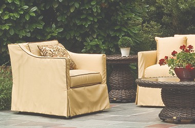 two chairs and woven tables in an outdoor setting