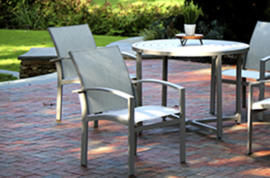 round table with four chairs on a brick patio