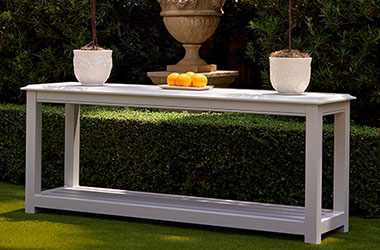 Light brown square table topped with food and drink