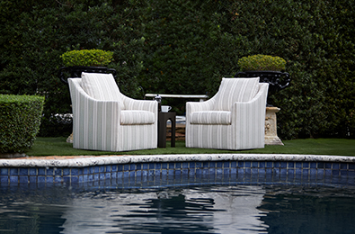 cushioned chair with a swivel base in an outdoor setting